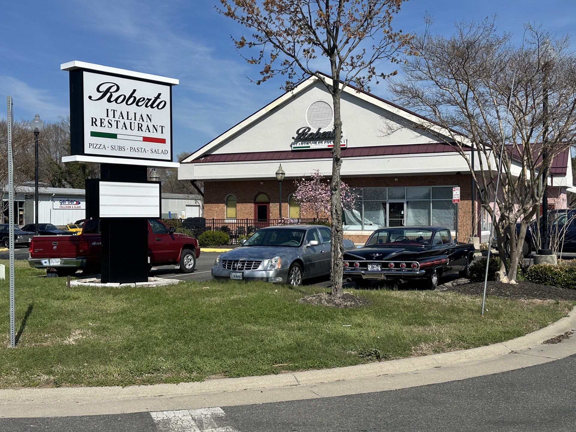 Exterior view of Roberto's Italian Restaurant with cars parked outside.